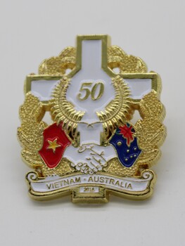 Commemorative Pin - A White cross with 50 in gold in centre.