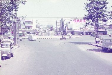 Main road, vehicles and roundabout with central monument.