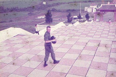 Dr Major Peter Byrne on the steps of the Cemetery for the fallen.