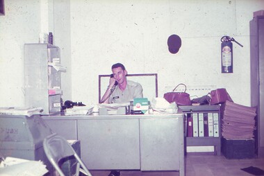 Lt Ray Harvey on the phone at his desk.