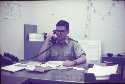 Lt Steve Phillips on the phone at his desk.