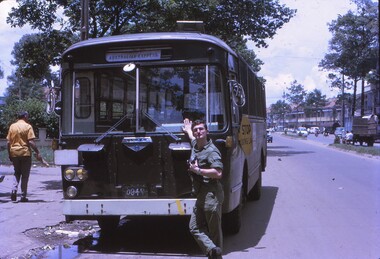 Cpl Gunther (Zac) Reissig leaning on the front of the HQ AFV bus.