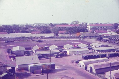 View of rear of Tpt compound with buildings and helicopters.