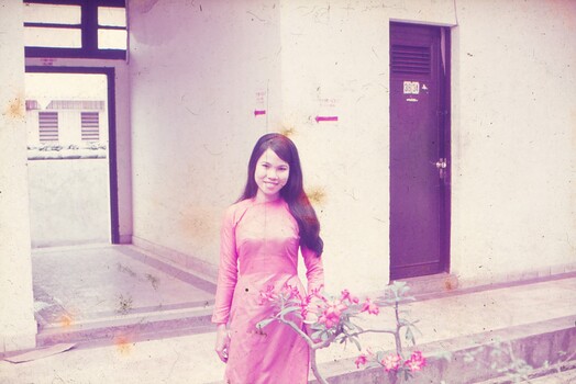 Female Thai interpreter in pink dress.