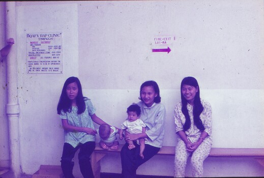 Babies awaiting needles with carers.