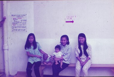 Babies awaiting needles with carers.