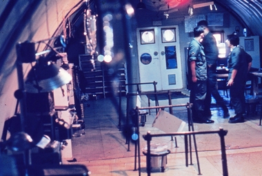 Soldiers inside operating theater in circular galvanized hut.