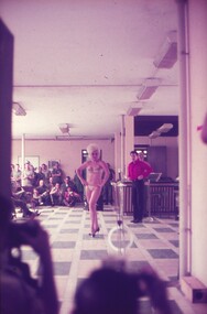 Female entertainer in bikini and black high heels.
