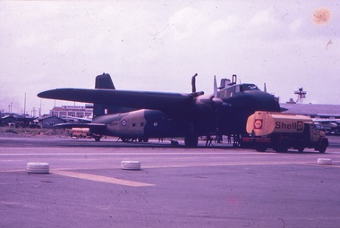 A yellow Shell truck refuelling an aircraft on the tarmac.