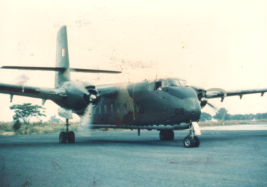 A coloured photograph of a Caribou plane on the ground.