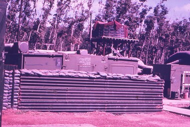 Corrugated iron sheets surrounding sand bags forming a fortified barrier.