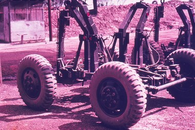 Metal frame cart, large tyres with deep tread for moving equipment.