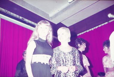 Two female entertainers posing for photo.