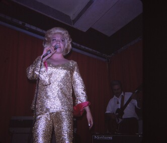 Female entertainer in gold shimmery outfit.