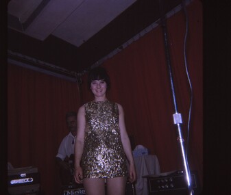 Female entertainer in gold dress.