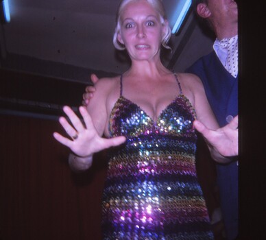 Female entertainer in a multi coloured stripe dress.