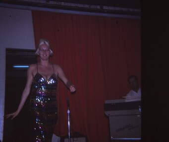Female entertainer walking onto stage.