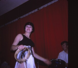 Female entertainer performing with tambourine.