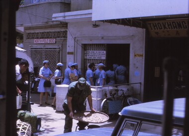 Red cross women entering building.