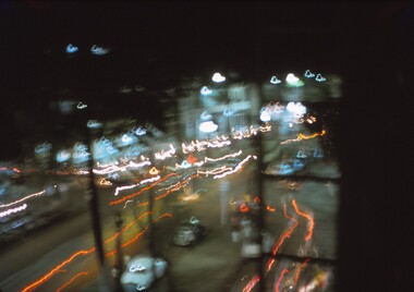 Blurred photo of street at night.