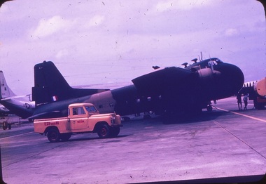 An aircraft on tarmac being refuelled.