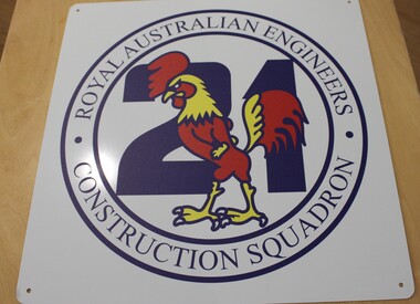 A white metal sign with the Royal Australian Engineers Construction squadron motif.