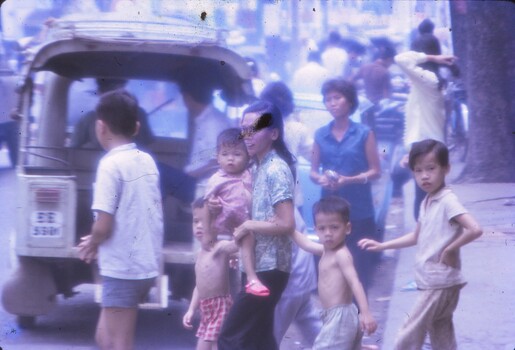 A local family crossing a street in Cholon Vietnam.