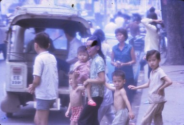 A local family crossing a street in Cholon Vietnam.