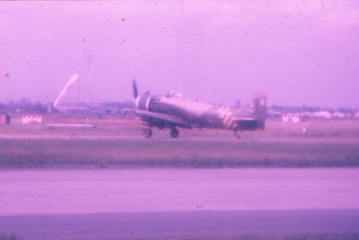 Single engine aircraft taxiing on runway.