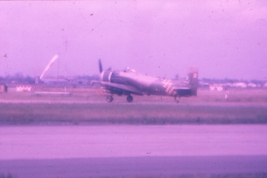 Single engine aircraft taxiing on runway.