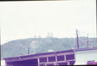 Radars atop a hill in distance.