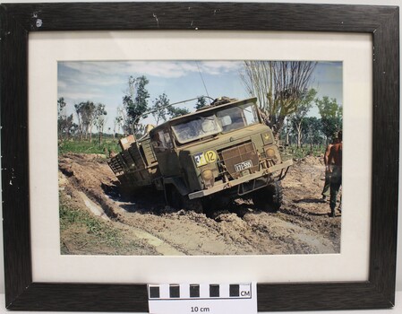 A Framed Coloured Photograph of a MK V International Cargo Truck Bogged