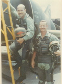 A coloured photograph of two pilots in uniform.