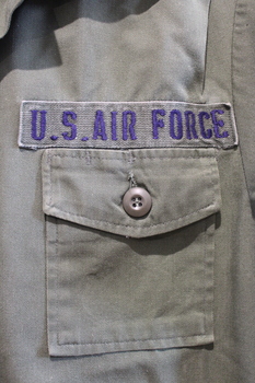Close up of U.S Air Force badge about left breast pocket.