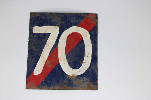 Metal blue square sign with red diagonal stripe, running top right to bottom left, and white number 70.
