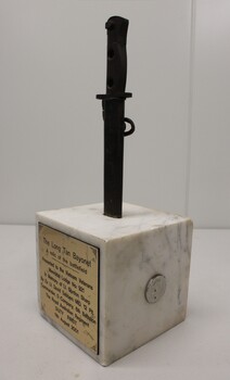 Queen Elizabeth War Medal on right side of Marble block.