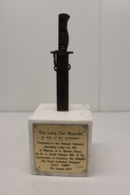 Bayonet in Scabbard fixed in Marble Block with dedication to Lt Gordon Sharp.