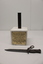 Bayonet laying in front of Marble block with scabbard fixed.