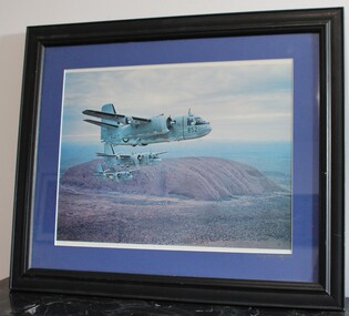 Framed coloured photo of three tracker planes flying over Uluru (Ayers rock) in formation.