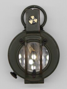 A khaki coloured metal compass.