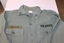 United States army green long sleeve shirt with metal rank badges on collar the name of "Palmer" on right hand top pocket.