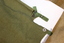 Khaki army issue woollen blanket with press studs and tabs to join the blanket it half.