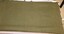 Khaki army issue woollen blanket with press studs and tabs to join the blanket it half.