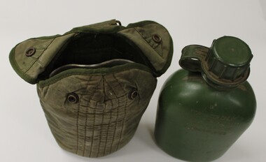 A drinking water bottle with canvas pouch.