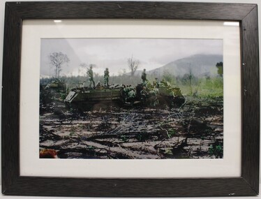 Two Tracked M113 Vehicles with Soldiers on Top and on the Ground