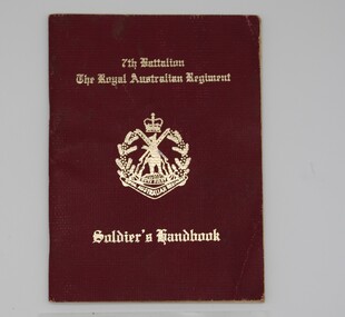 Maroon coloured booklet with gold lettering. 