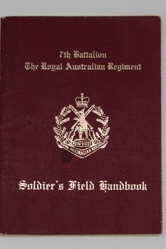Small maroon coloured cardboard handbook with gold lettering 