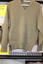 A khaki long sleeved woollen army issue jumper.