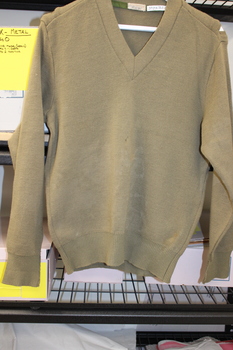 A khaki long sleeved woollen army issue jumper.