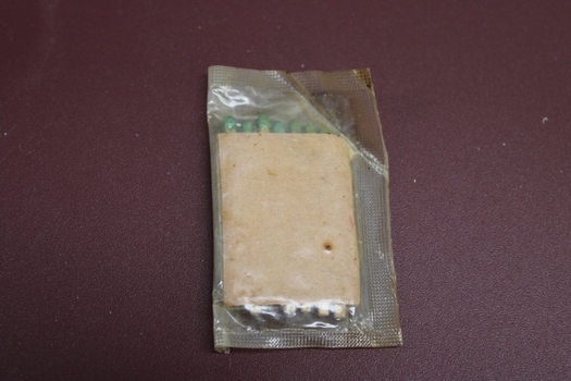 Sealed clear wrapper with seven green tipped matched contained in a brown cardboard cover.